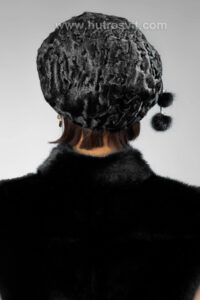 Шапки з натурального хутра каракуляберет жіночий, чорного кольору, розмір регулюється|Цены на шубы и зимние шапки из меха каракуль - мягкий берет, цвет черный, шапка регулируется резинкой по ободу. Очень износостойкая, не боится плохой погоды. На фото девушка в жилетке из норки.